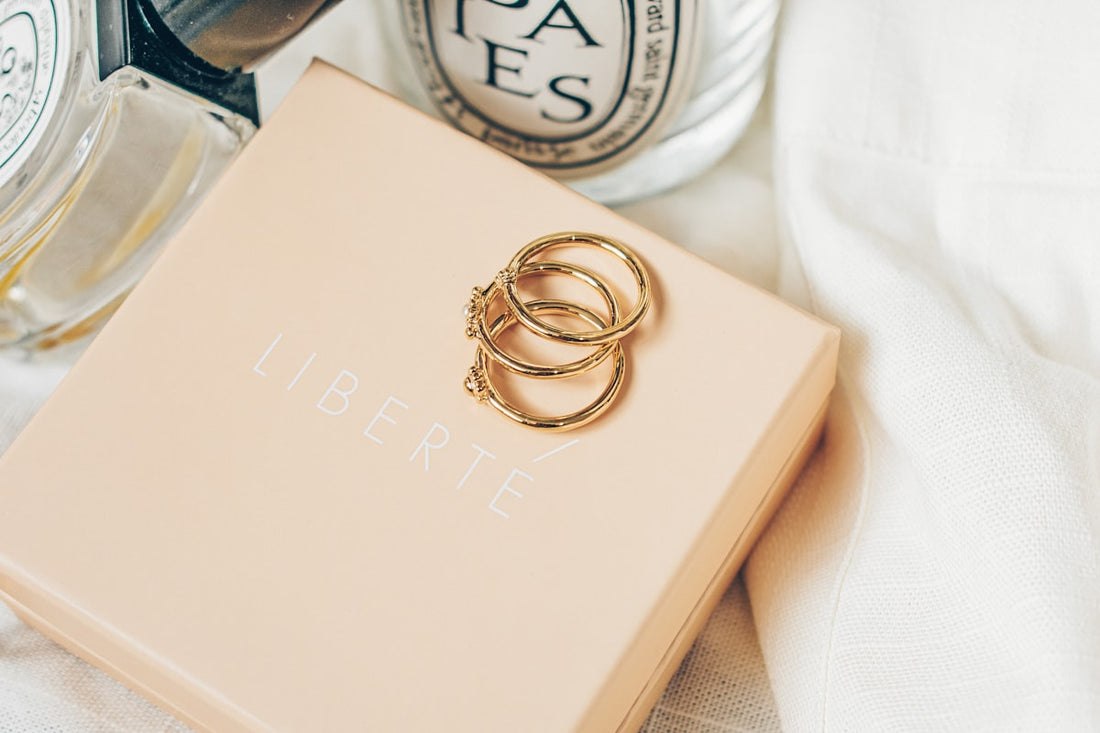Woman gently cleaning a delicate gold-tone necklace with a soft cloth — jewellery care guide UAE 2026 by AJIVA Fashion