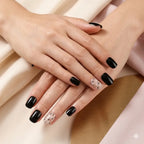 "Woman wearing black and nude star print press-on nails on both hands"