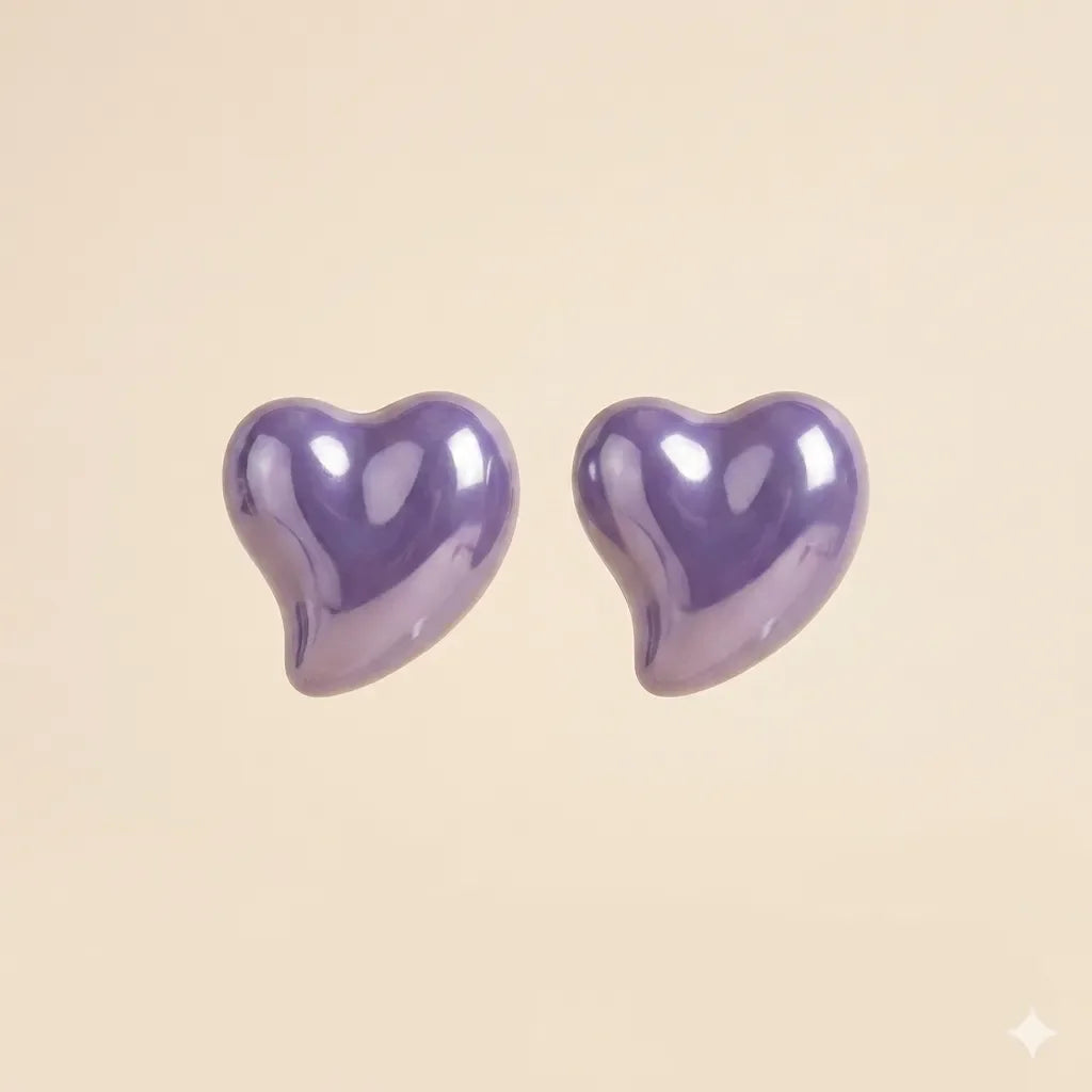 Pair of glossy purple puffy heart stud earrings with high-shine lacquer finish on beige background