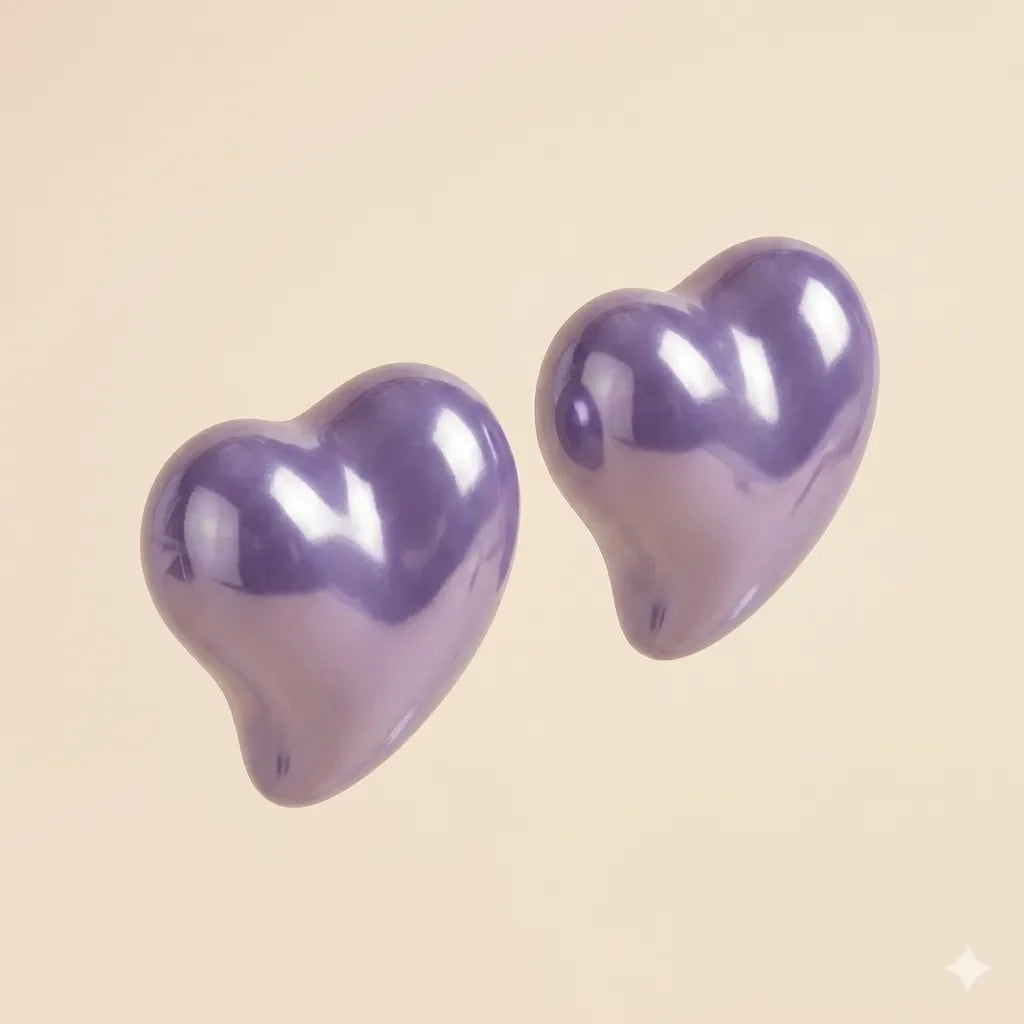 Pair of glossy purple puffy heart stud earrings with high-shine lacquer finish on beige background
