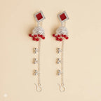 Silver red mirror stone jhumka earrings with long ghungroo kan chain and hook on beige background