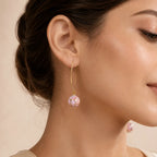"Woman wearing pink mosaic bead drop earring with gold wire hook"