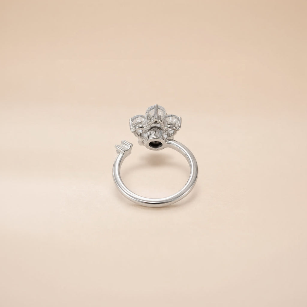 Silver flower cluster ring with round CZ petals and open band on satin background