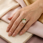 "Close-up of CZ daisy ring with emerald leaves worn on hand"