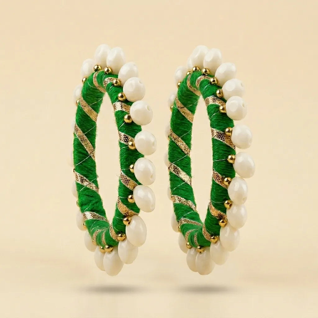  "Set of two green silk thread bangles with pearl beads and gold zari"