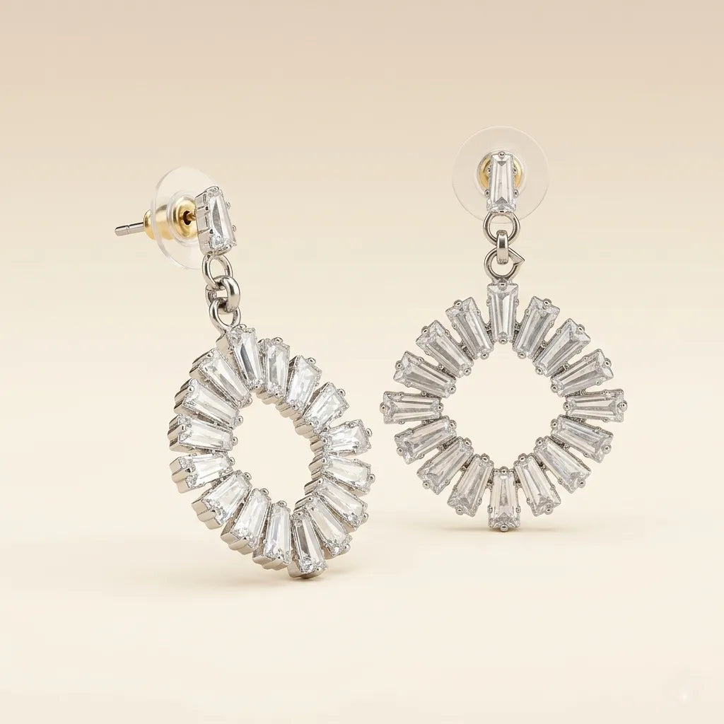 Silver rhodium-plated baguette cubic zirconia open wreath circle drop earrings on beige background