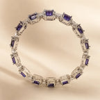 Silver royal purple square cut CZ pave octagonal halo bangle bracelet showing full 360° link design on beige background