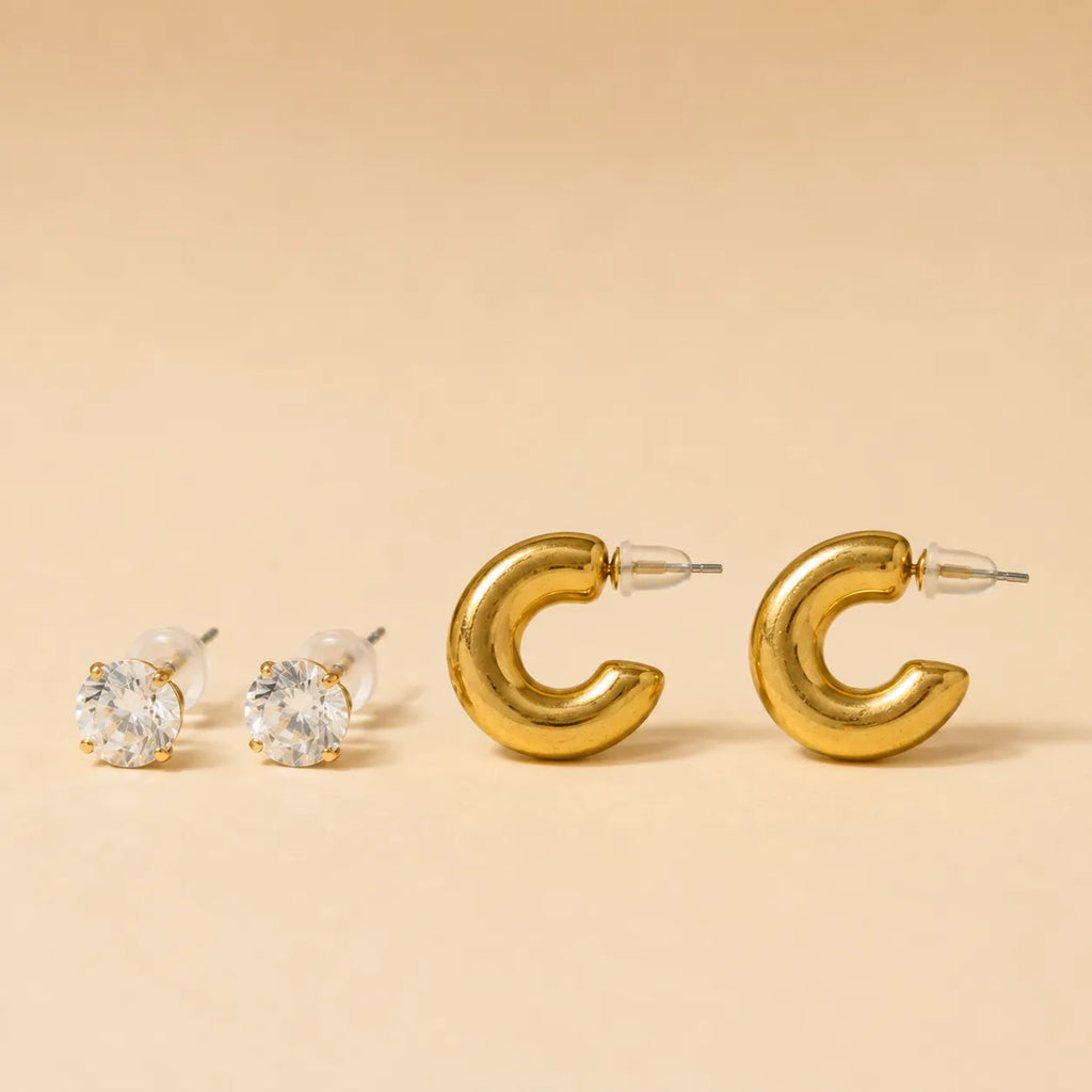  "Set of gold chunky hoop earrings and CZ stud earrings on beige background"
