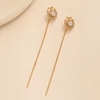 "Gold halo crystal earrings with scroll detail and chain threader"