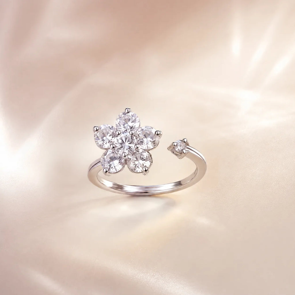 Back view of silver crystal flower open ring showing adjustable band and baguette accent
