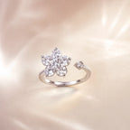 Back view of silver crystal flower open ring showing adjustable band and baguette accent