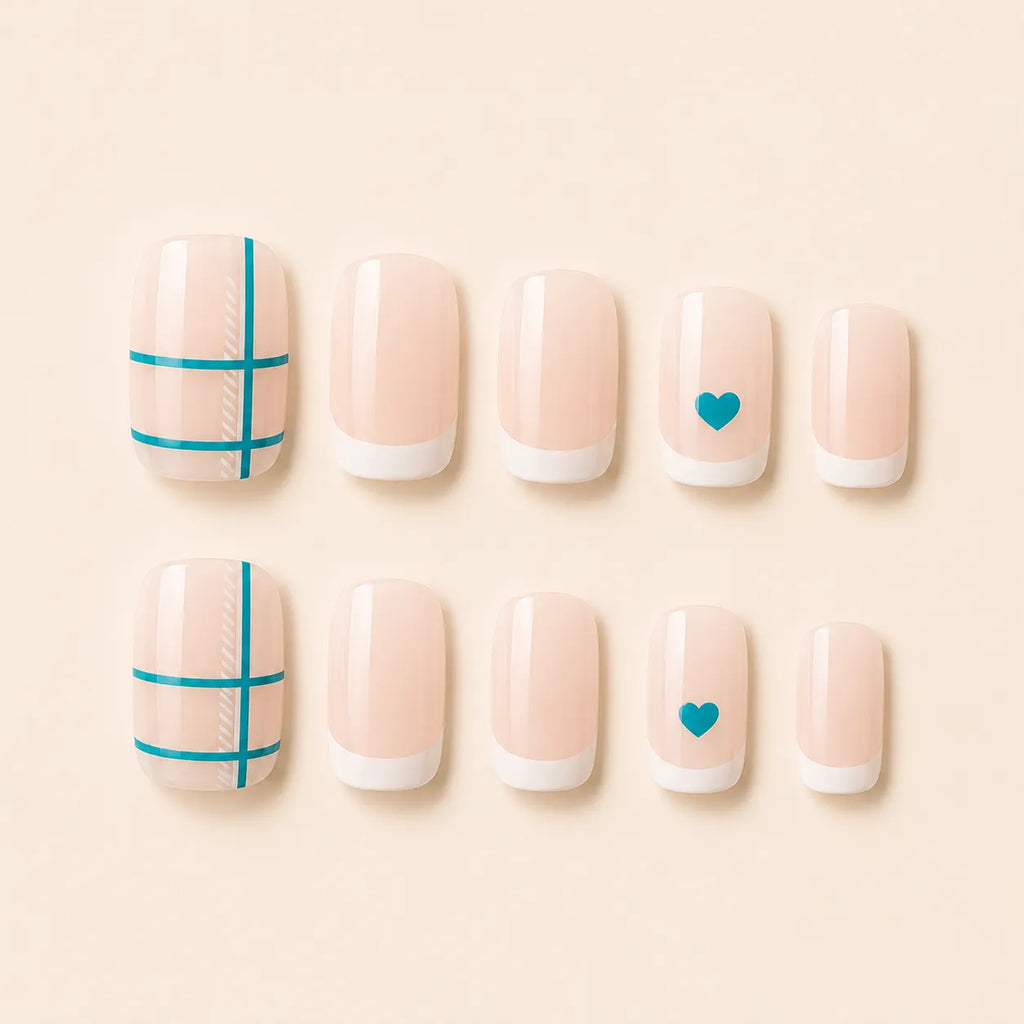 Set of 12 short square nude French tip press-on nails with teal crosshatch grid and teal heart accent nails on cream background