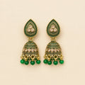 Pair of antique gold emerald green meenakari teardrop stud dome jhumka earrings with champagne crystal band and green bead drops on cream background
