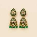 Pair of antique gold emerald green meenakari teardrop stud dome jhumka earrings with champagne crystal band and green bead drops on cream background