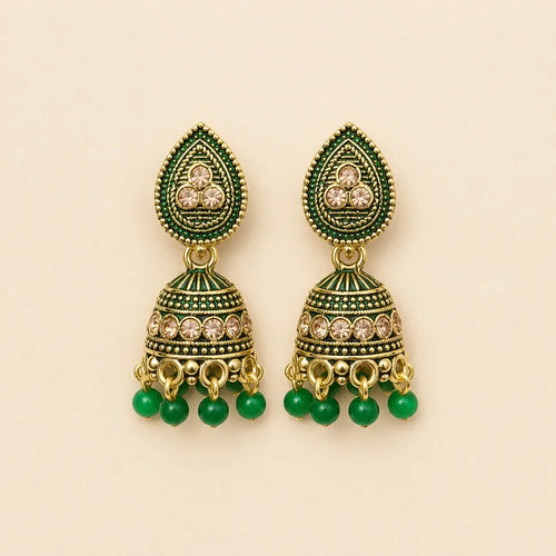 Pair of antique gold emerald green meenakari teardrop stud dome jhumka earrings with champagne crystal band and green bead drops on cream background