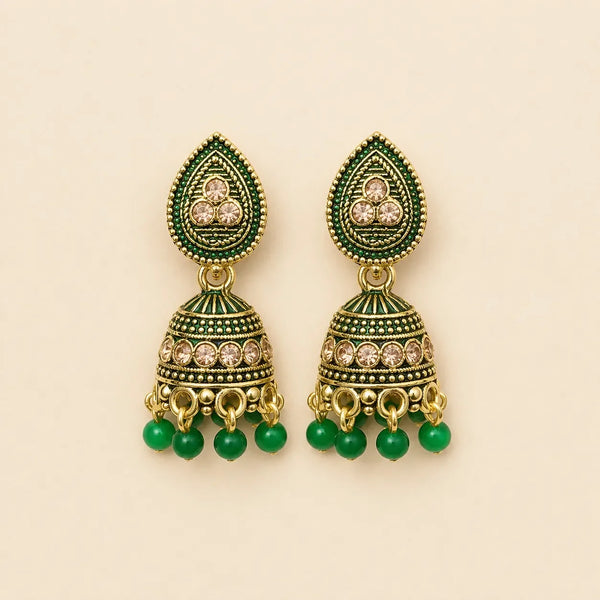 Pair of antique gold emerald green meenakari teardrop stud dome jhumka earrings with champagne crystal band and green bead drops on cream background