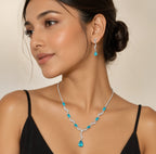 Model wearing blue crystal teardrop necklace and matching dangle earrings with black dress