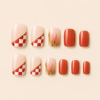 "Set of terracotta and red checkerboard press-on nails with floral accent"