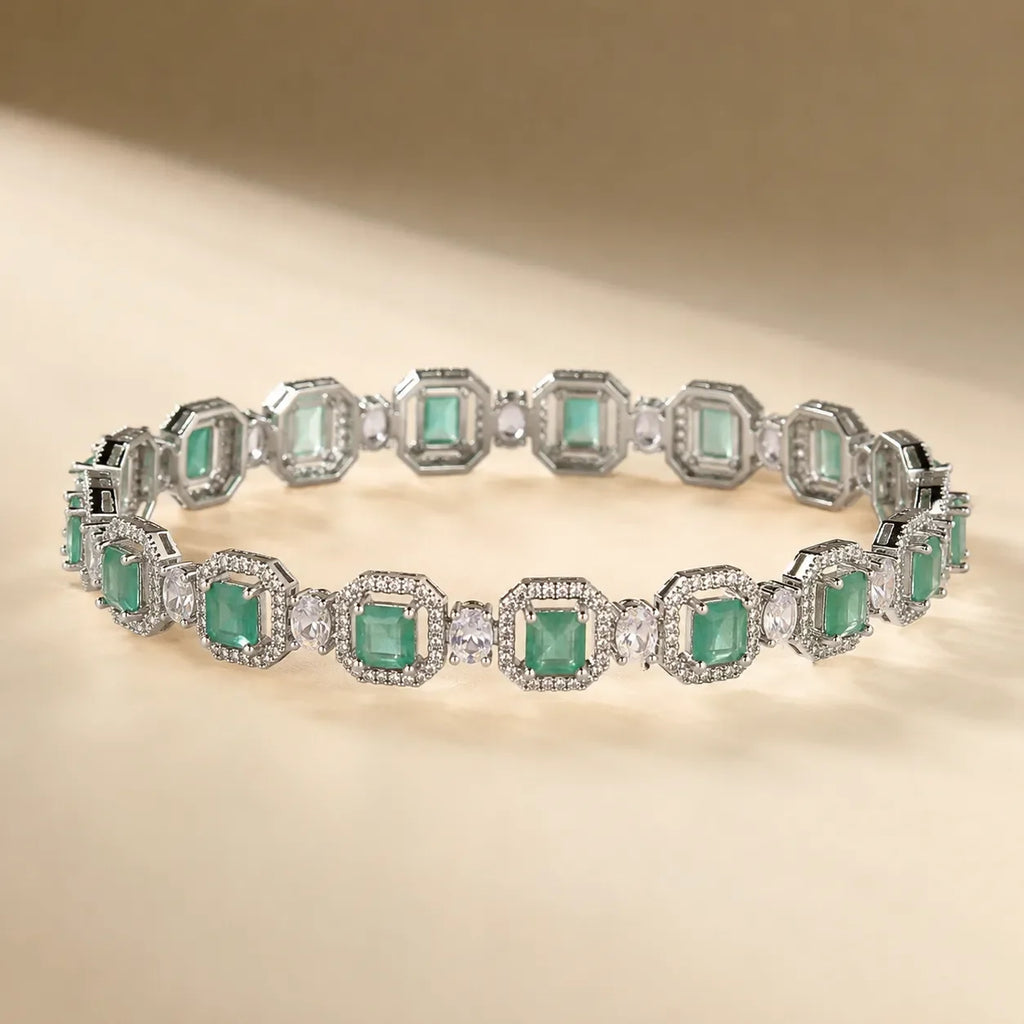 Silver mint seafoam green emerald cut octagonal halo CZ bangle bracelet showing continuous link design and crystal detail on beige