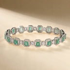 Silver mint seafoam green emerald cut octagonal halo CZ bangle bracelet showing continuous link design and crystal detail on beige