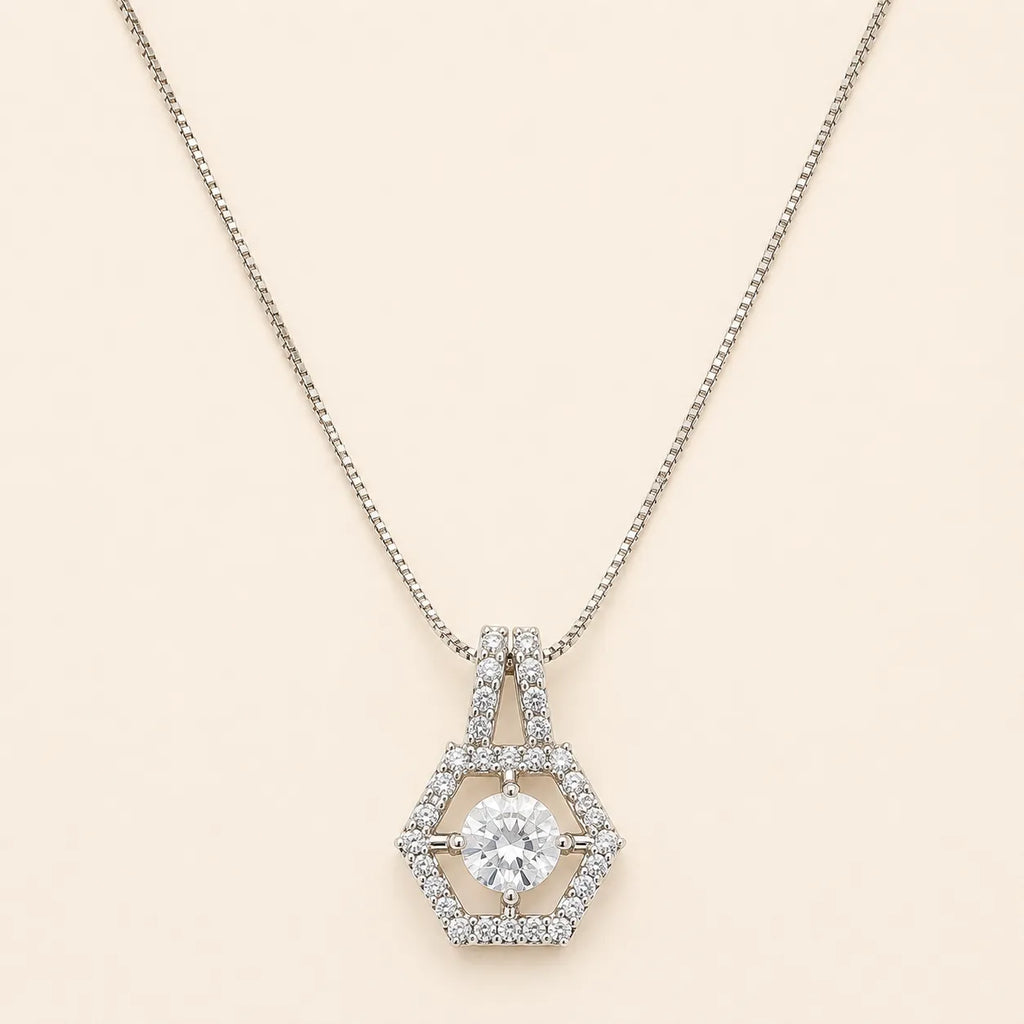 Silver hexagon halo necklace with round cut CZ center stone and double-bail chain detail on beige background