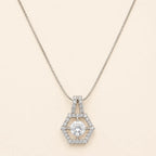 Silver hexagon halo necklace with round cut CZ center stone and double-bail chain detail on beige background