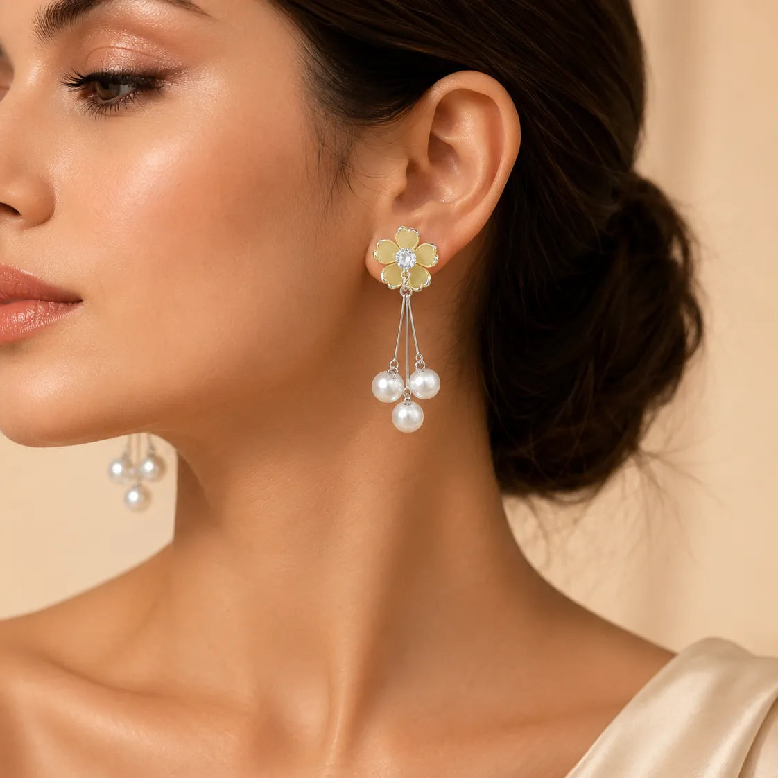 "Woman wearing yellow flower pearl drop earring with updo hairstyle"