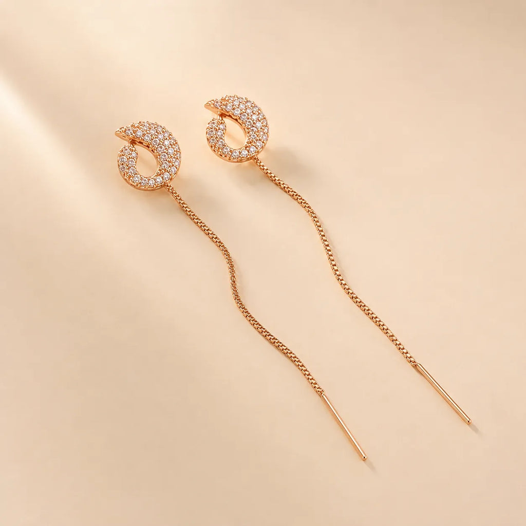 "Rose gold pave crystal earrings with chain threader detail"