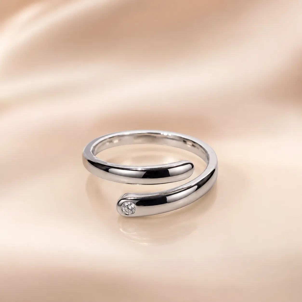  "Silver open wrap ring with round CZ stone accent detail"