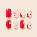 "Set of red glossy and cream watercolor press-on nails with flower accents"