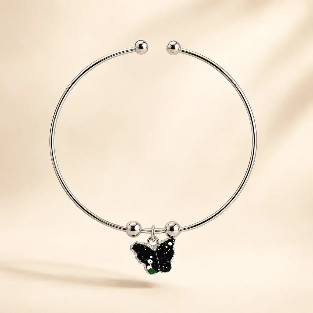 Single silver open cuff bangle with black green galaxy butterfly enamel charm and ball-bead accents