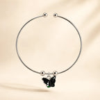 Single silver open cuff bangle with black green galaxy butterfly enamel charm and ball-bead accents