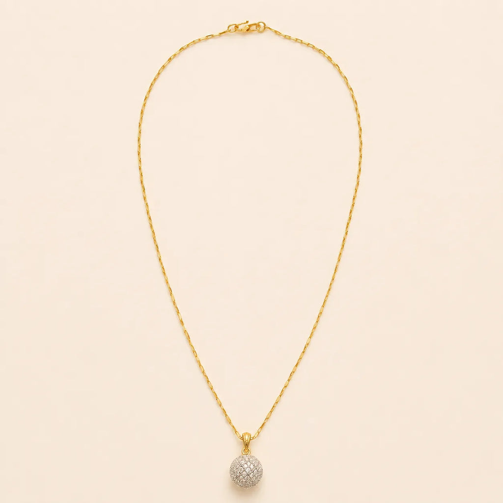 Gold plated paperclip chain necklace with pavé crystal ball pendant, full length view on beige background