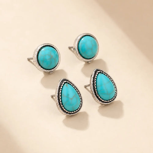 Turquoise stud earring set showing round and teardrop pairs on beige background