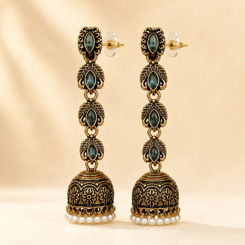 Antique gold jhumka earrings with blue crystal stones and pearl drops, traditional Indian dangle earrings on gold background