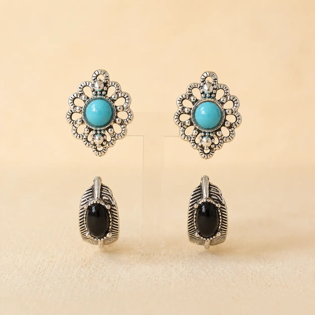 "Set of two stud earrings, turquoise flower design and black onyx leaf design"