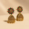 Pair of antique gold Navratna sunflower floral stud jhumka earrings with ruby emerald petals champagne crystal dome and pearl drops on cream background