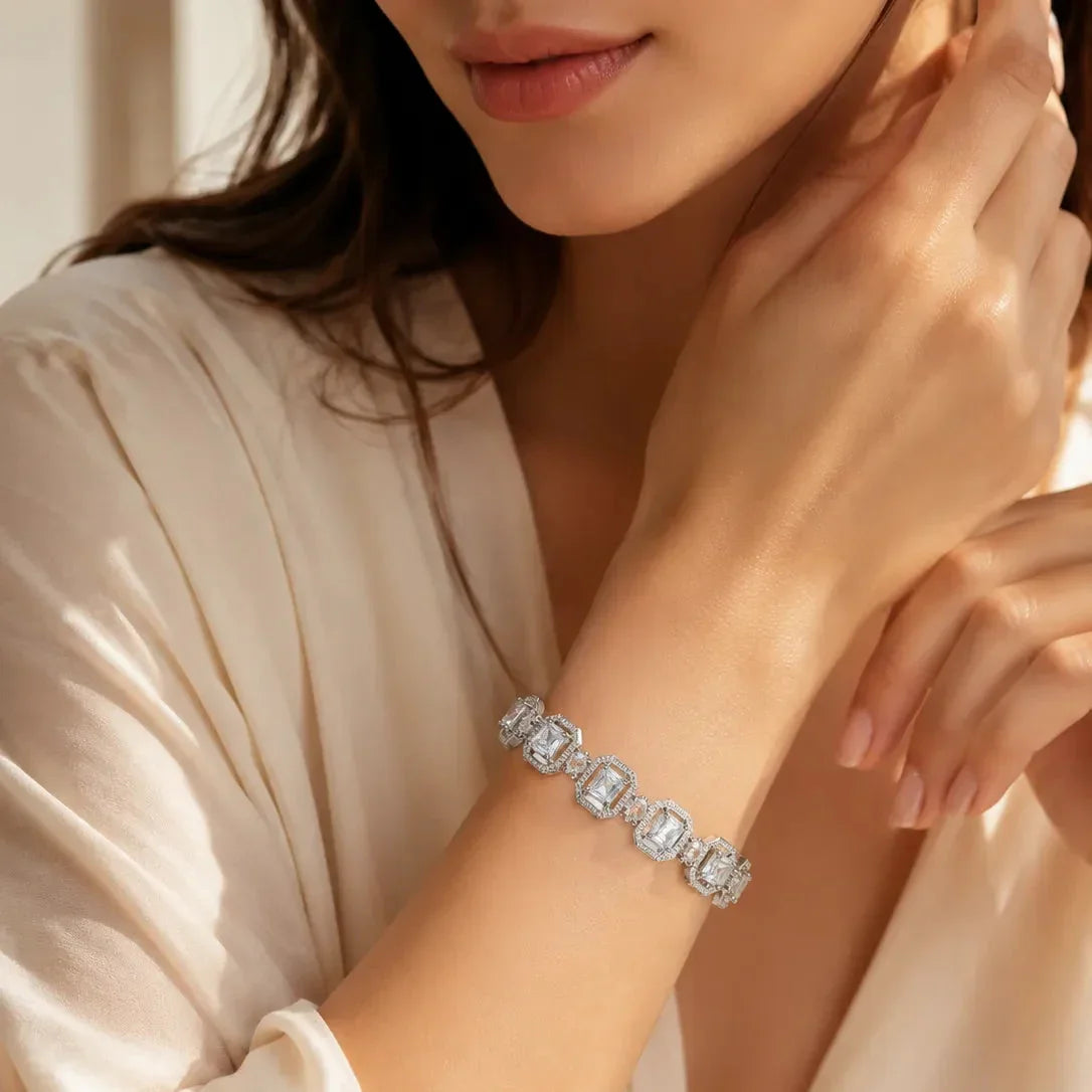 Woman wearing silver white emerald cut CZ halo bangle bracelet — diamond-look variant of the mint green bangle set