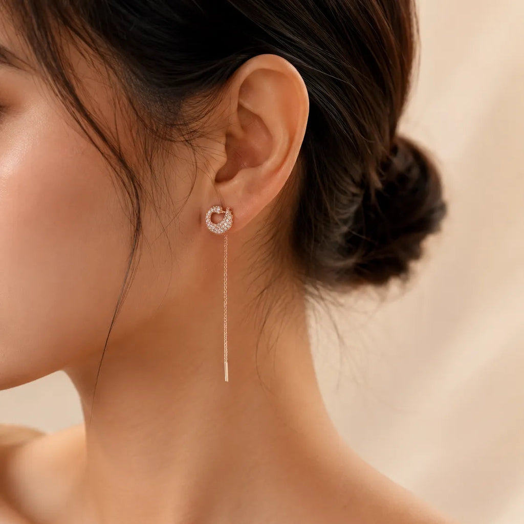 "Woman wearing rose gold CZ threader earring with chain drop"