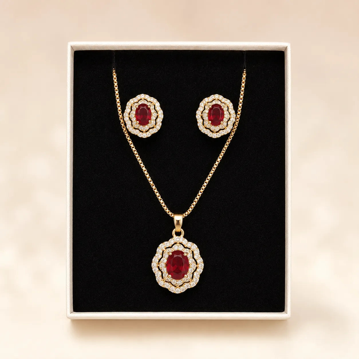 Ruby halo necklace and earring set displayed in gift box on black velvet insert