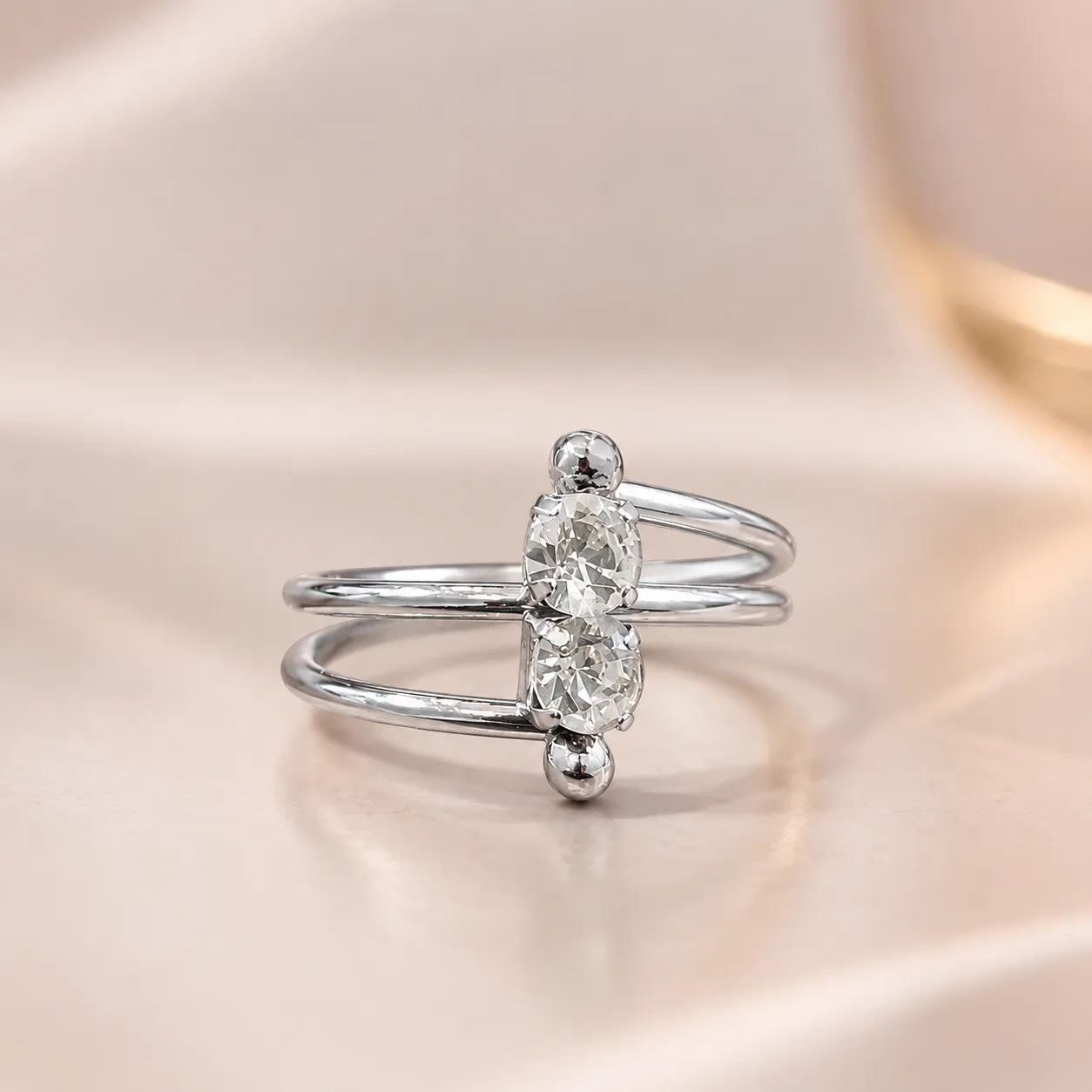  Close-up of silver two stone ring showing crossover double band and vertical CZ stones