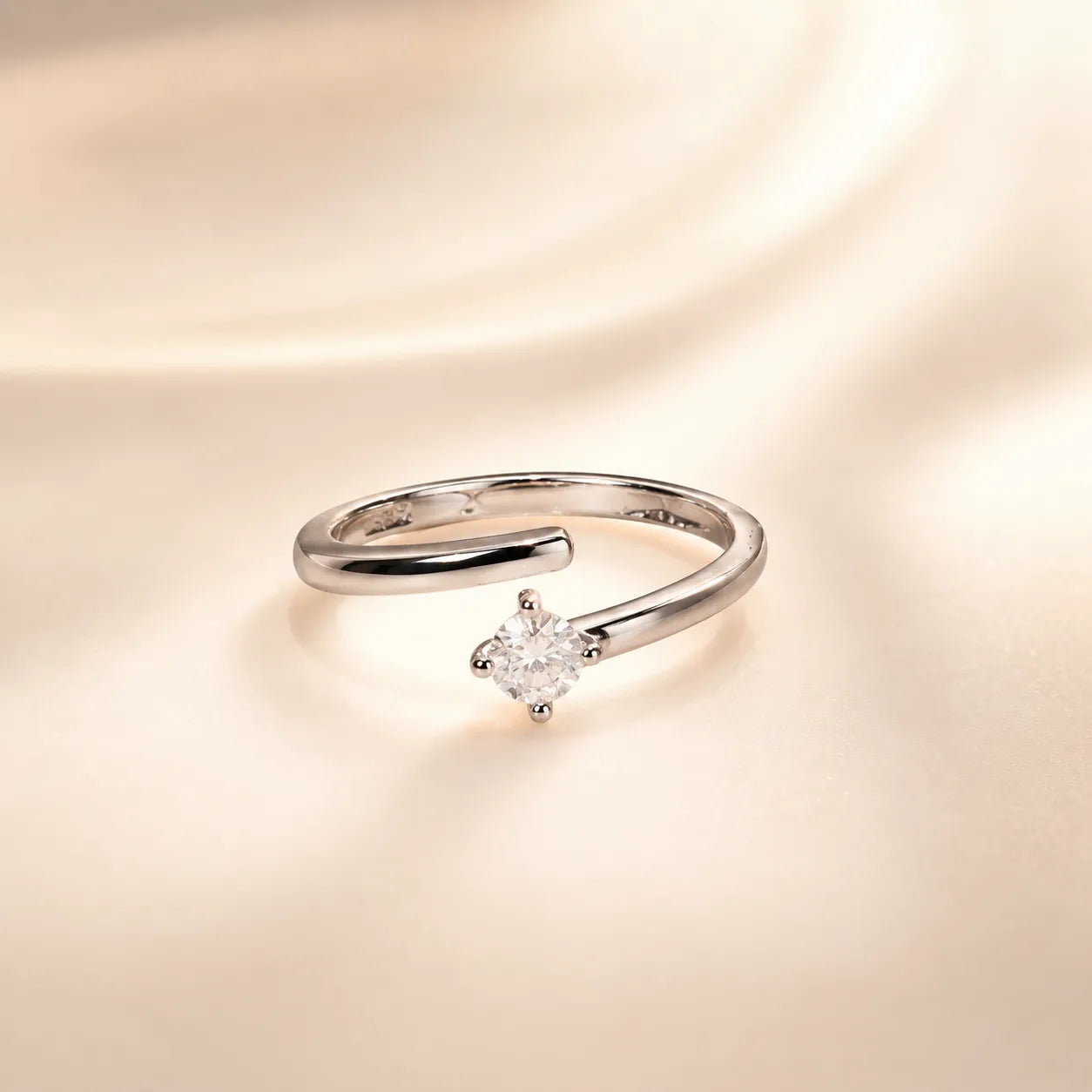 "Close-up of silver wrap ring featuring single round cut crystal"