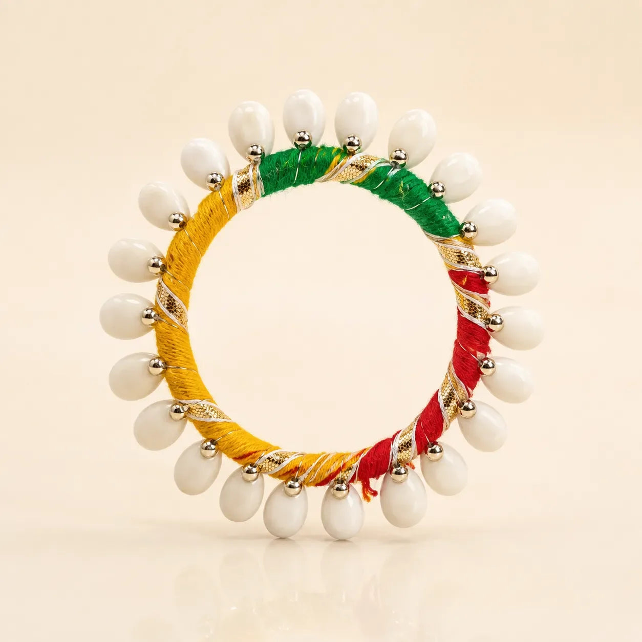 Back view of multicolor silk thread bangle showing full white shell oval drop circumference and tricolor thread detail