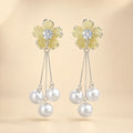  "Pair of yellow flower earrings with CZ center and dangling pearl tassels"