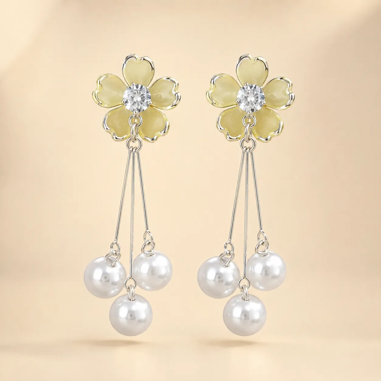 "Pair of yellow flower earrings with CZ center and dangling pearl tassels"