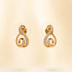 "Gold swirl stud earrings with pave crystals at an angle"
