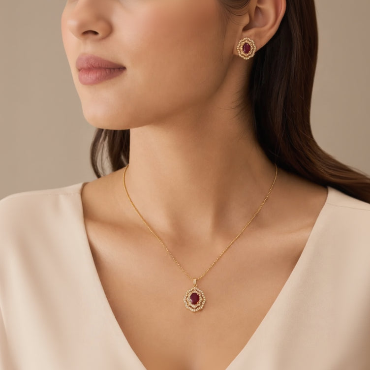 Model wearing gold ruby halo pendant necklace and matching stud earring
