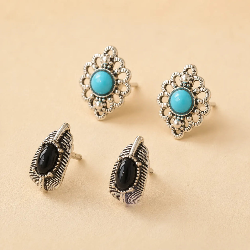 "Set of two stud earrings, turquoise flower design and black onyx leaf design"