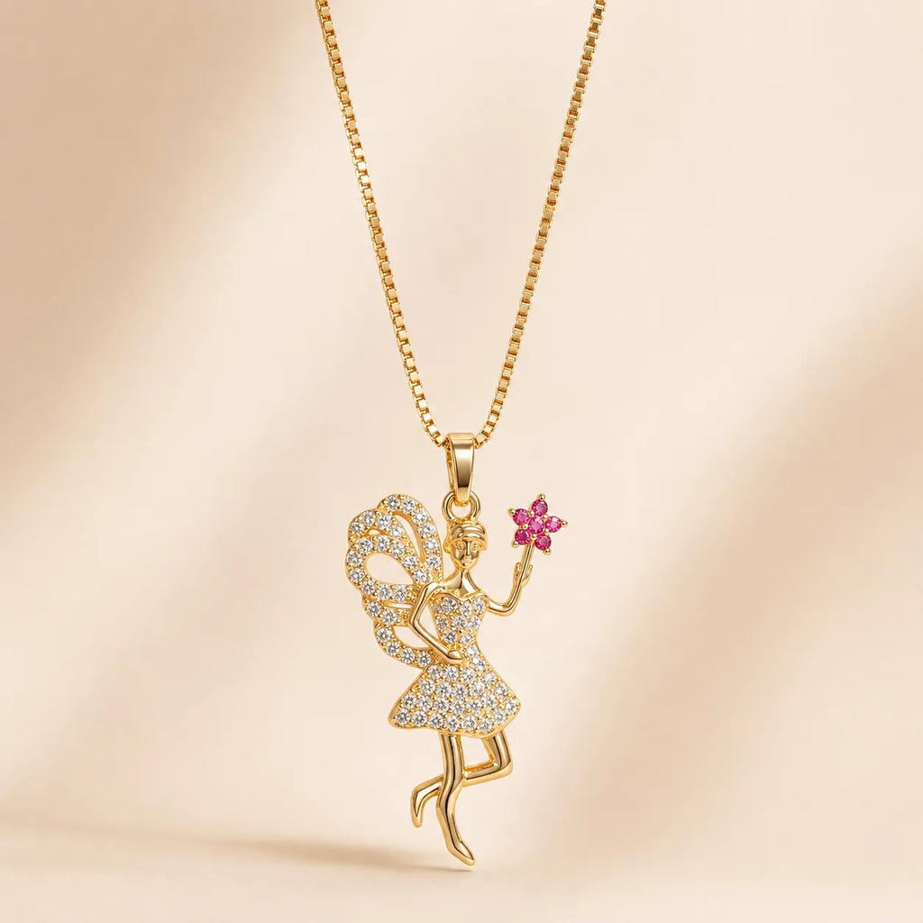 Gold fairy pendant necklace with pink crystal flower, full chain flat lay with lobster clasp on cream background