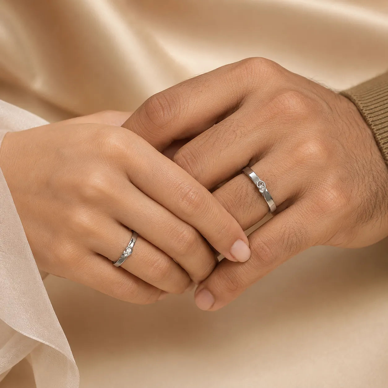 Couple holding hands showing matching his and hers heart CZ promise rings